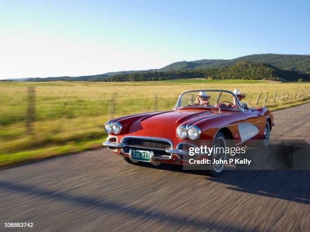 two women in red convertible - convertible stock pictures, royalty-free photos & images