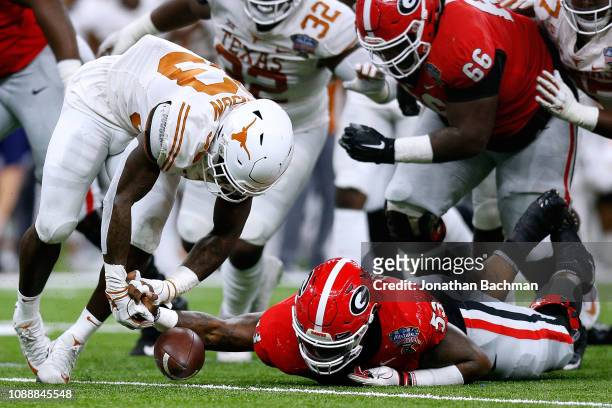 Lamont Gaillard of the Georgia Bulldogs recovers a fumble over Gary Johnson of the Texas Longhorns during the first half of the Allstate Sugar Bowl...