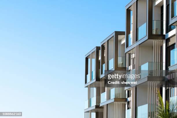 corner of an apartment building, dubai, uae - modern home exterior stock-fotos und bilder