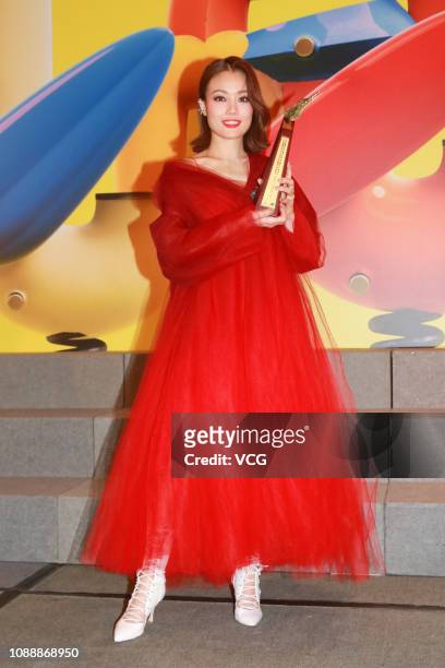 Singer/actress Joey Yung poses with the trophy backstage during the 2018 Ultimate Song Chart Awards Presentation at Hong Kong Convention and...
