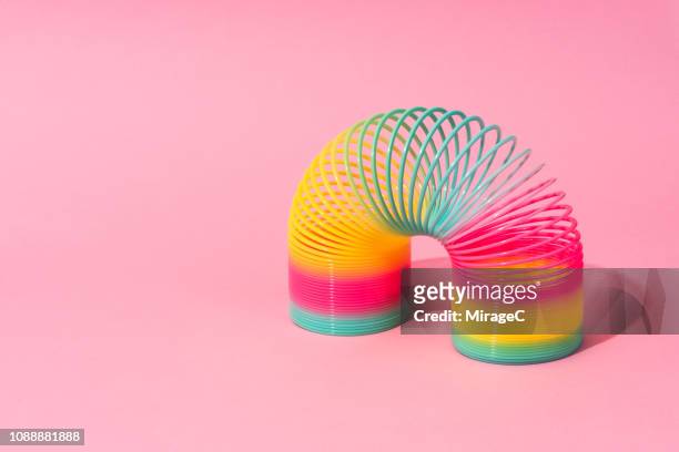 rainbow coil toy - bent stock pictures, royalty-free photos & images