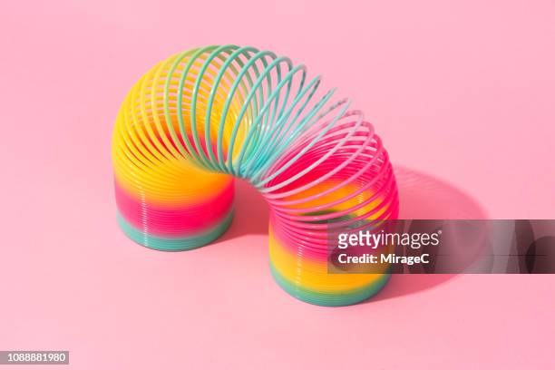 rainbow coil toy - metal coil toy stock-fotos und bilder