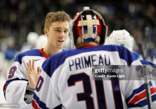 Goaltender Spencer Knight congratulates teammate Cayden Primeau following a win versus Finland at the IIHF World Junior Championships at the...
