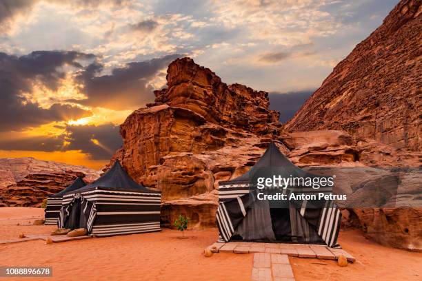tourist tents in wadi rum desert at sunset. jordan. - the nomad hotel stock pictures, royalty-free photos & images