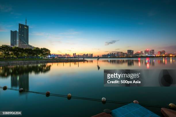 illuminated city at sunset, hefei, anhui, china - hefei stock pictures, royalty-free photos & images