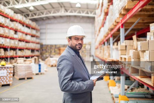 warehouse manager checking inventory on tablet pc - rack stock pictures, royalty-free photos & images