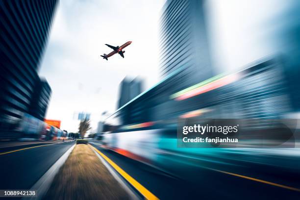 low angle view of a commercial plane flying over urban road - low flying aircraft bildbanksfoton och bilder