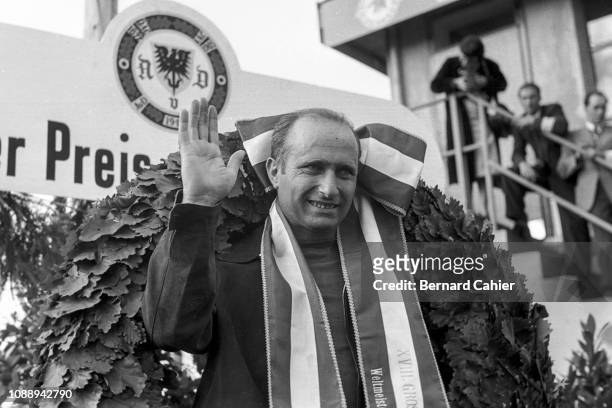 Juan Manuel Fangio, Grand Prix of Germany, Nurburgring, 05 August 1956. Juan Manuel Fangio on the podium waving after his victory in the 1956 German...