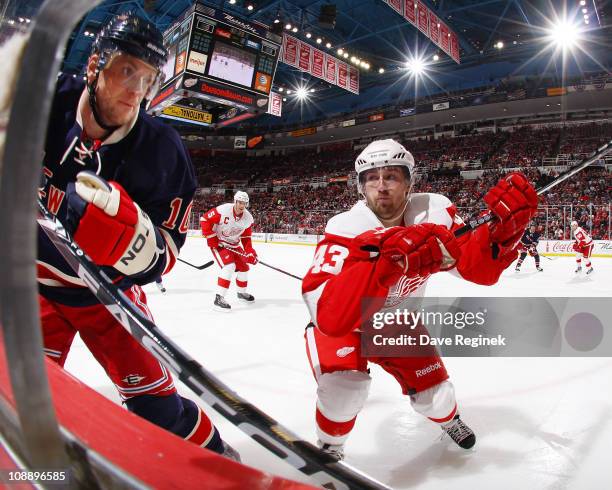 Darren Helm of the Detroit Red Wings pursues Marian Gaborik of the New York Rangers during an NHL game at Joe Louis Arena on February 7, 2011 in...