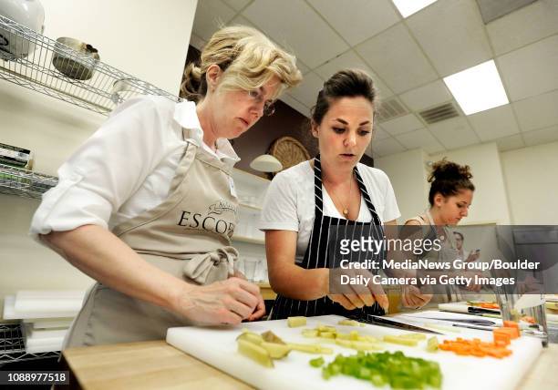 Lisette Bogner, of Chadron, Neb. Left, gets some feedback from Chef Andrea Pitchford, during a knife skills class at the Auguste Escoffier School of...