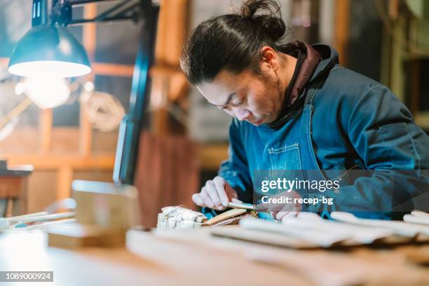 asian man making craft from wood - traditional craftsman stock pictures, royalty-free photos & images