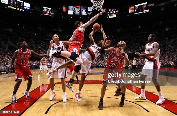 Andre Miller of the Portland Trail Blazers shoots the ball against Omar Asik and Taj Gibson the Chicago Bulls on February 7, 2011 at the Rose Garden...