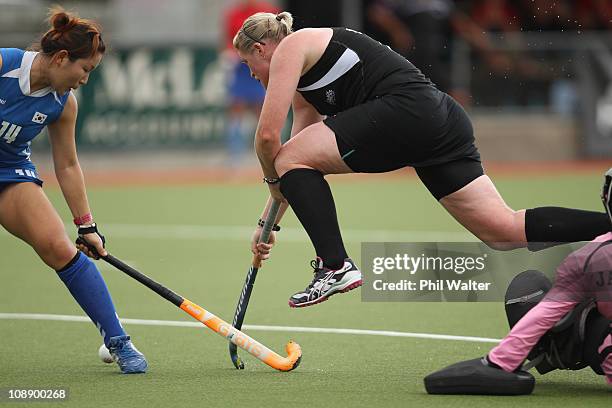 Katie Glynn of New Zealand takes the ball over the top of goalkeeper Soo Ji Jang of Korea during the Women's match between the New Zealand...