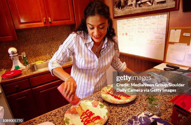 Lupita Ramirez-Dudley general manager at Earl House Historic Inn in downtown Boulder prepares crepes with a fruit sauce in the kitchen Thursday...