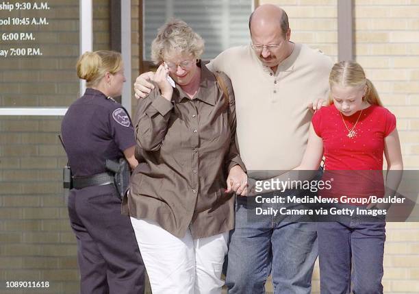 Sandy Solt, left, wipes tears from her eyes as she walks away from Tabor Funeral Home in Brighton with her husband Mike and daughter Jori on Sunday....