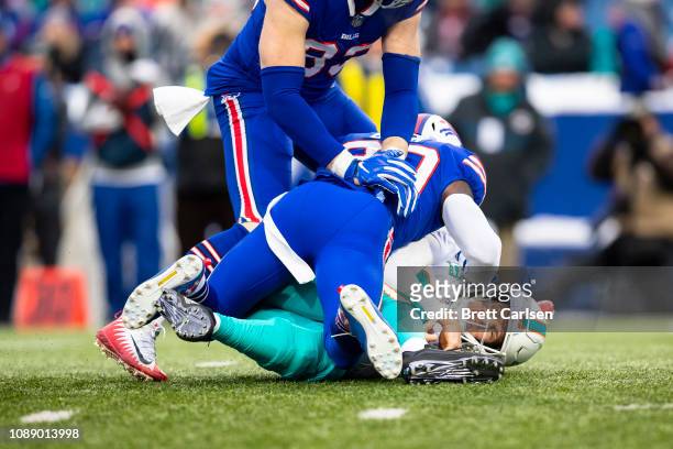 Rafael Bush of the Buffalo Bills sacks Ryan Tannehill of the Miami Dolphins during the first quarter at New Era Field on December 30, 2018 in Orchard...