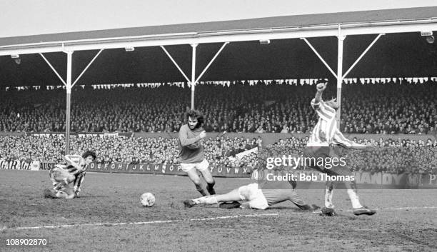 George Best of Manchester United scores past Stoke City goalkeeper Gordon Banks during their Division One match played at the Victoria Ground,...