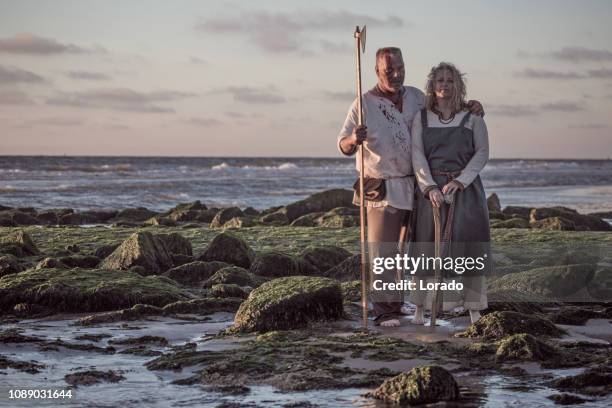 male and female viking warrior couple in wild highland countryside - france v scotland stock pictures, royalty-free photos & images