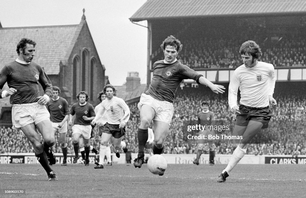 Pat Rice Ireland England striker Mike Channon and Pat Rice of Northern Ireland battle ...