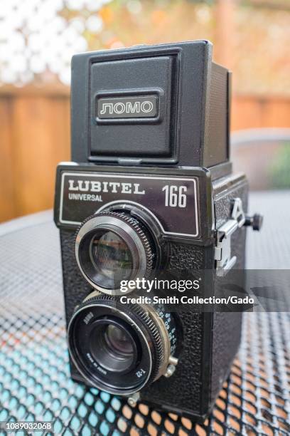 Close-up of the Soviet made Lubitel 166 Universal Twin Lens Reflex vintage camera from the original LOMO brand on a metal surface showing focusing...