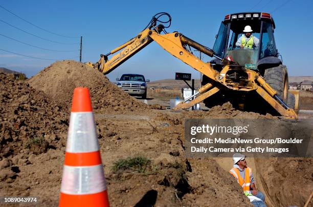 Workers from Fredrick-based Hirschfield Backhoe and Pipeline raise a water line to its original position and restrain joints after a mine shaft...