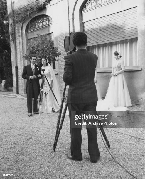 Cameraman films American actor Tyrone Power and Mexican actress Linda Christian at their wedding at the Santa Francesca Romana church in Rome, 27th...