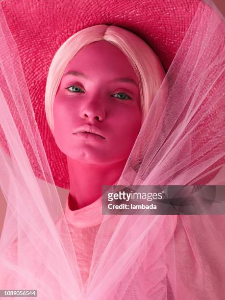 portrait of young woman in monochrome pink tones - arts culture et spectacles photos stock pictures, royalty-free photos & images