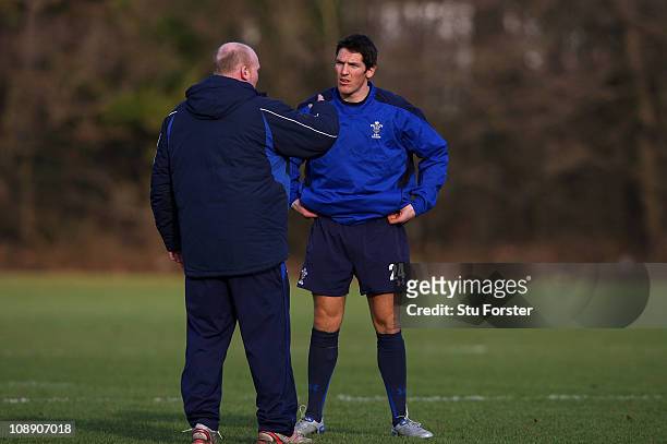 Wales flyhalf James Hook chats with coach and former number 10 Neil Jenkins during Wales training at The Vale complex on February 8, 2011 in Cardiff,...