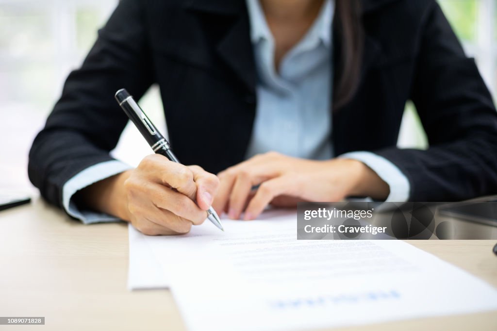 Business woman signing documents . Deal concept.