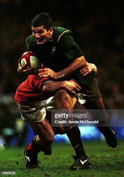 Joost van der Westhuizen of South Africa breaks the tackle of Ian Gough of Wales during the International match between Wales and South Africa at the...