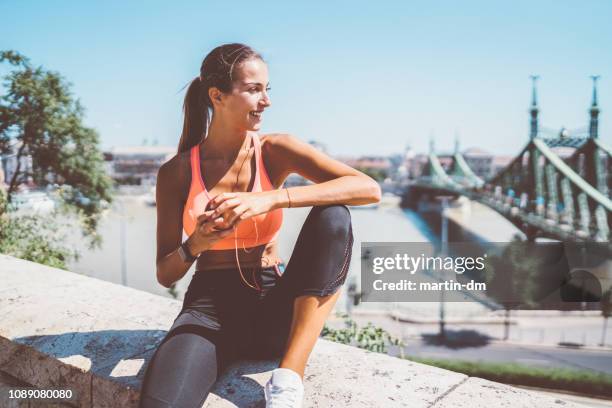 sportswoman jogging in the city - budapest train stock pictures, royalty-free photos & images