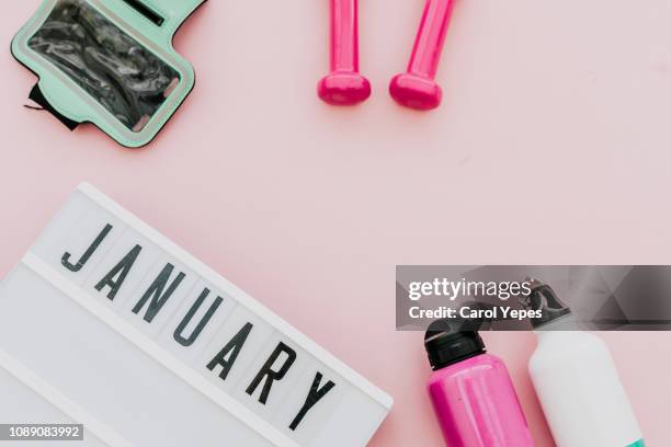 flat lay shot of woman sport equipment, , water, in pink background - calendario español fotografías e imágenes de stock
