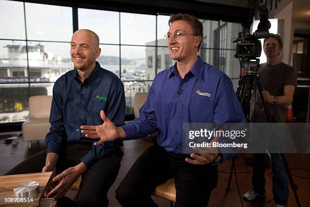 Lyndon Rive, co-founder and chief executive officer of SolarCity, right, speaks while Peter Rive, fellow co-founder and chief operating officer,...