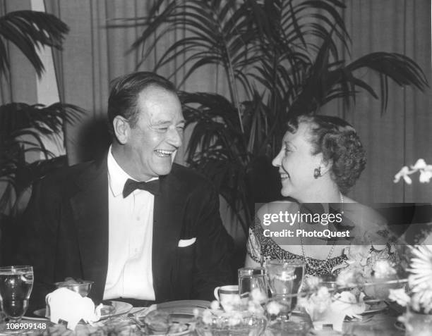 American actor John Wayne and US First Lady Mamie Eisenhower attend a dinner in honor of Congressional Republicans at the Sheraton Hotel, Washington...