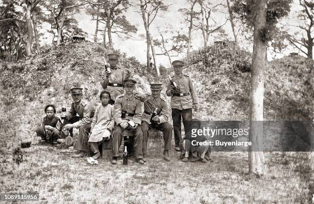 German soldiers with Chinese children during occupation, Jiaozhou Bay, China, 1905.