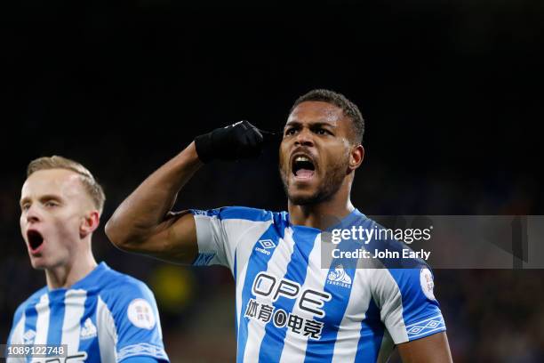 Steve Mounie celebrates scoring the opening goal during the Premier League match between Huddersfield Town and Burnley FC at John Smith's Stadium on...