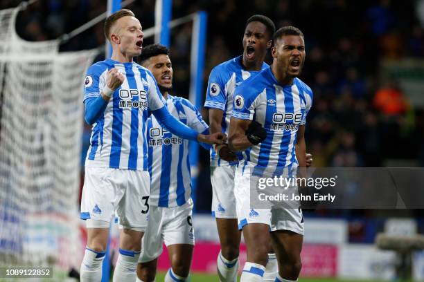Steve Mounie celebrates scoring the opening goal during the Premier League match between Huddersfield Town and Burnley FC at John Smith's Stadium on...