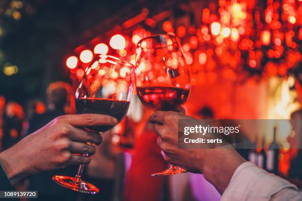 couple toasting wine glasses - romantic restaurant posh stock pictures, royalty-free photos & images