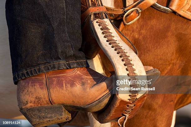 a cowboy boot in a horse stirrup, detail - stirrup stock pictures, royalty-free photos & images