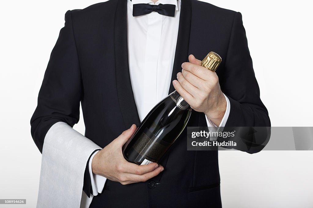 A sommelier holding a bottle of champagne