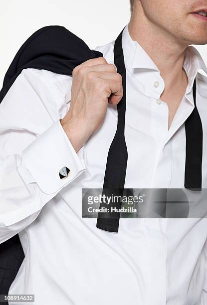 a man wearing a tux shirt with the collar open and an untied bow tie, midsection - offener kragen stock-fotos und bilder