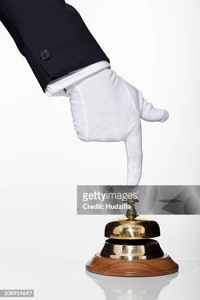 a butler pushing a service bell, focus on hand - white glove fotografías e imágenes de stock