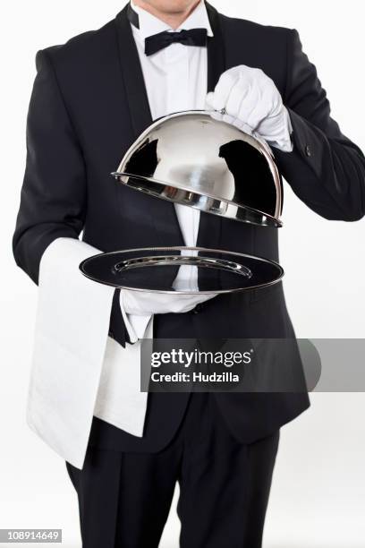 a butler taking the domed lid off an empty silver tray - grey glove stock pictures, royalty-free photos & images