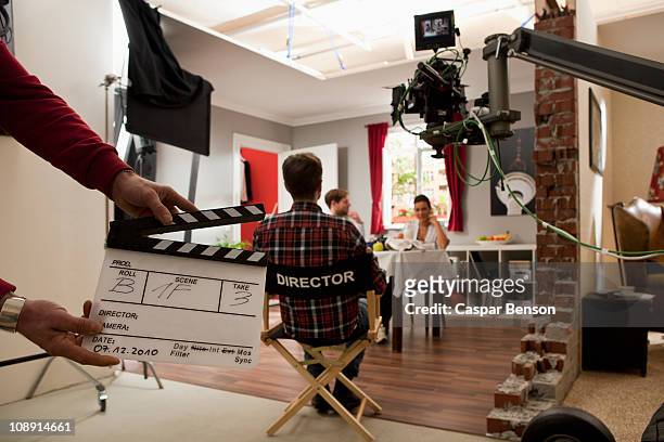 a director on a film set watching actors perform a scene - filming stock pictures, royalty-free photos & images