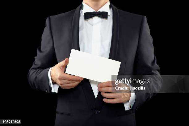 midsection of a man wearing a tuxedo and holding an envelope - smoking imagens e fotografias de stock