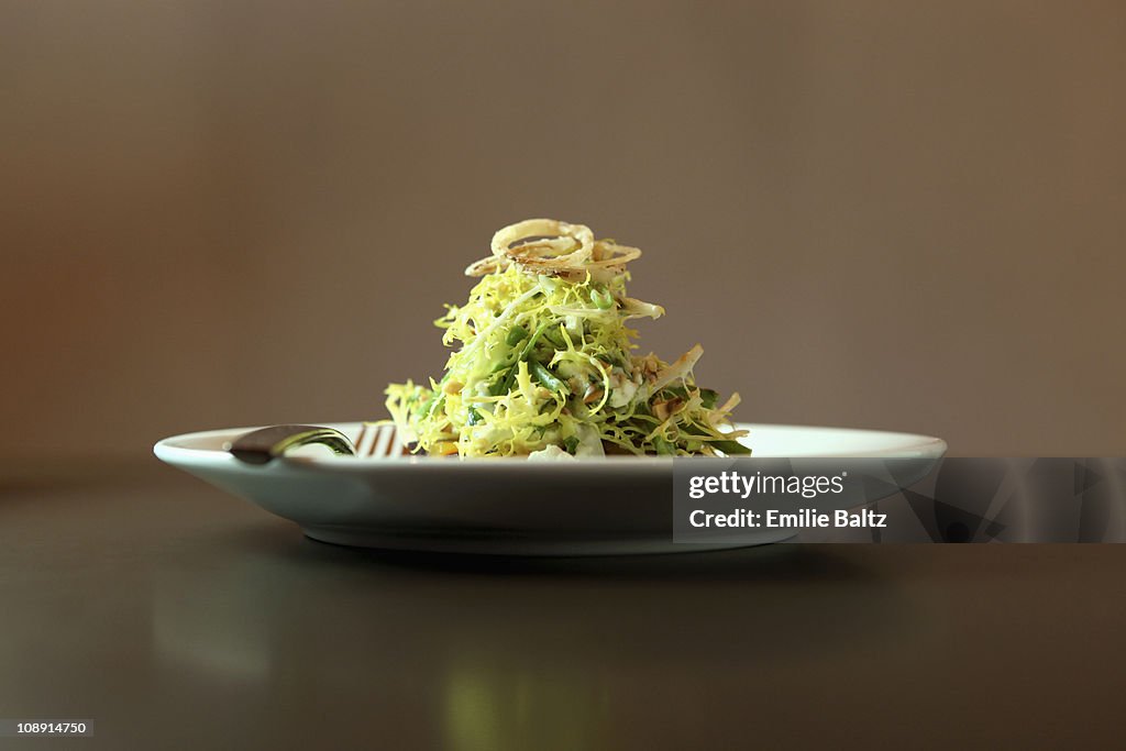 A salad garnished with fried onions