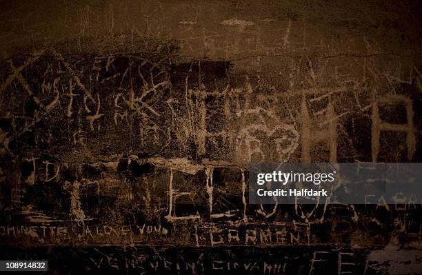 handwritten graffiti etched into a stone wall - handwriting texture stock pictures, royalty-free photos & images