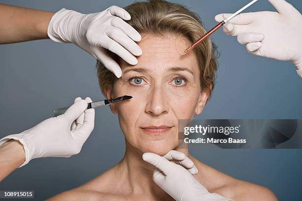 woman thinking about plastic surgery - plastische chirurgie stock-fotos und bilder