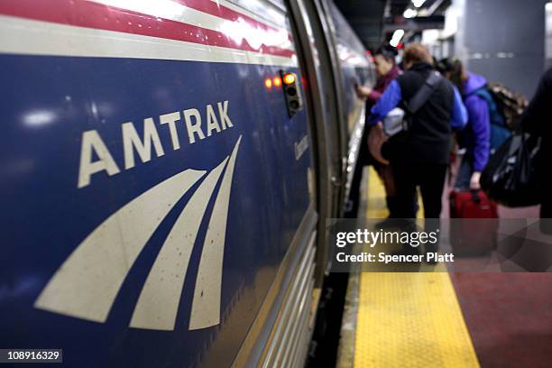 People board an Amtrak train at Penn Station on February 8, 2011 in New York City. Amtrak, a government-owned corporation, has joined up with New...