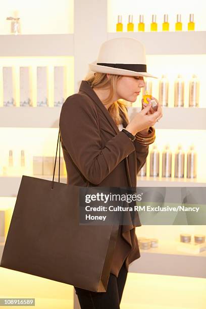 woman shopping - choosing perfume stock pictures, royalty-free photos & images
